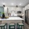 Spacious and well lit kitchen with wood flooring and stainless steel appliances