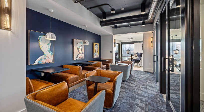 Coworking lounge with tables and leather chairs