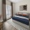One Bedroom with large windows with blinds